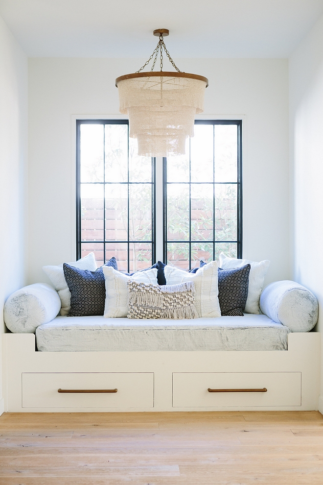 Custom window seat reading nook with black steel windows, Pehuen Pillows and made goods patricia chandelier natural #windowseat #blacksteelwindows #blackwindows #pillows