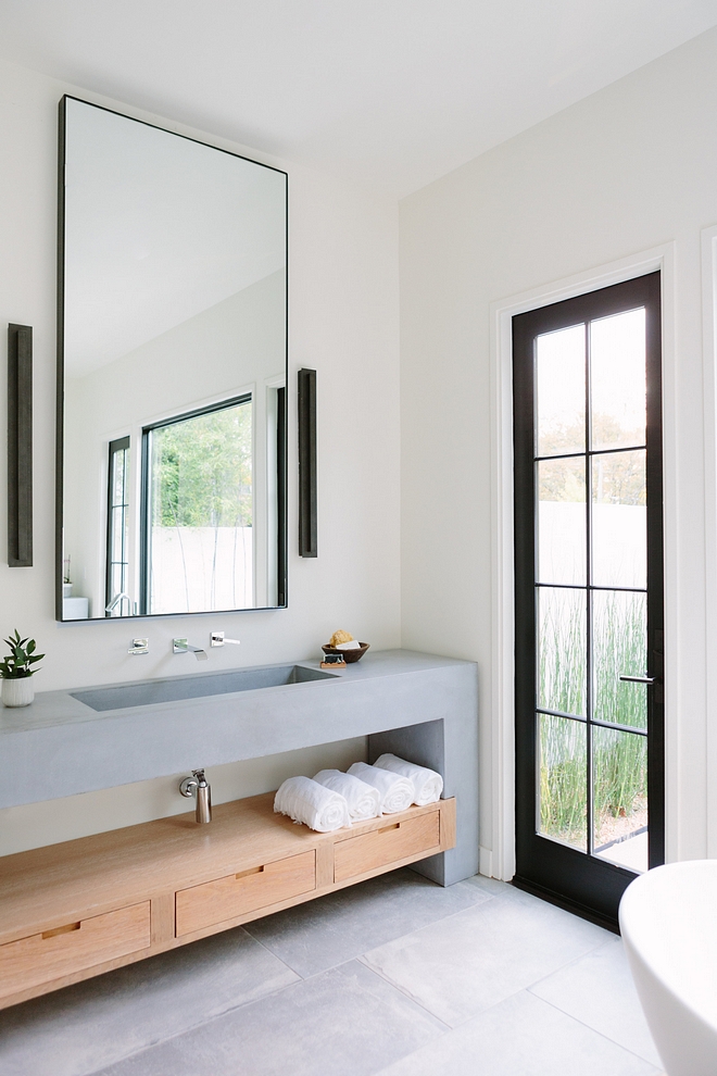 Bathroom Vanity The master bathroom features an unique concrete and wood vanity #Bathroom #bathroomvanity #concretevanity #woodvanity