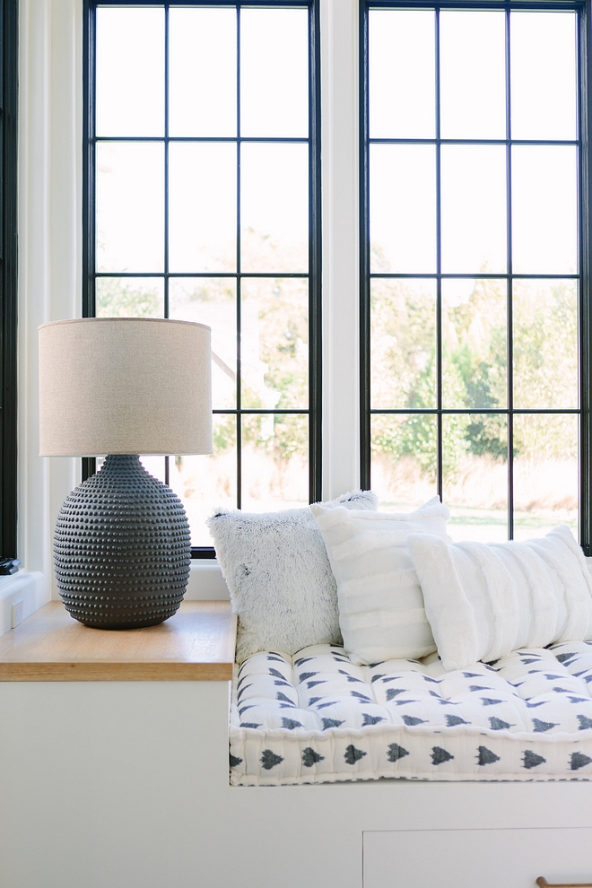 Reading Nook with built in bench The built in reading bench is their favorite place to read a book or take a nap in the sunshine #builtinbench #readingnook #blackwindows