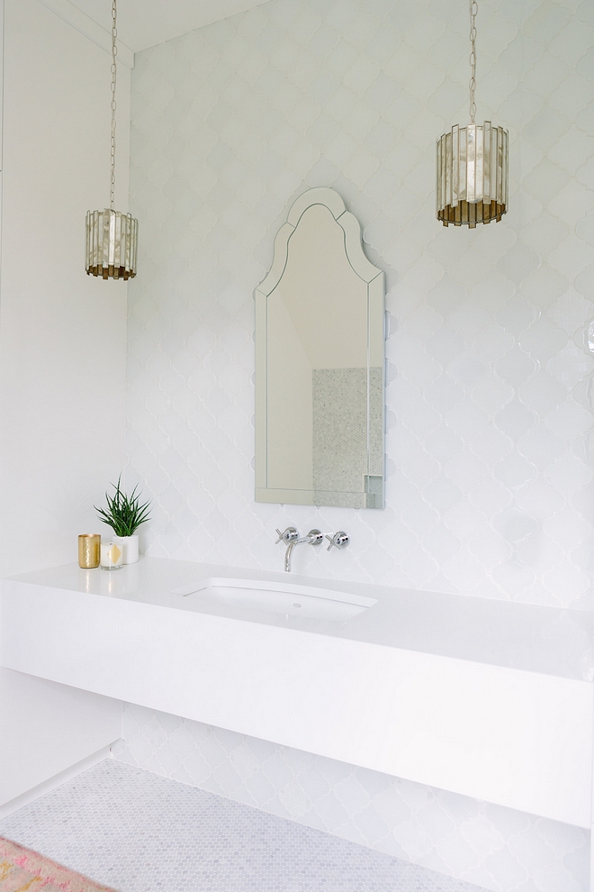 Bathroom with long floating vanity with white quartz countertop antique mirrored pendant lights and Arched Mirror #bathroom #floatingvanity #whitequartz #antiquemirrorpendants #ArchedMirror