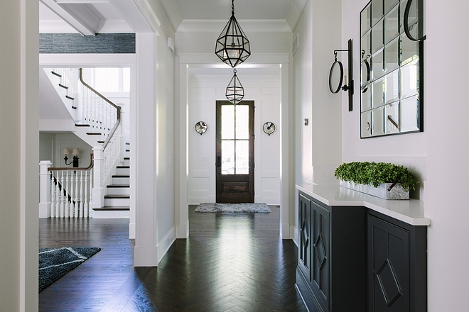 Dark hardwood floors This home comes to show that dark hardwood floors with white wall paneling is a classic choice that will always stand the test of time #darkhardwoodfloors