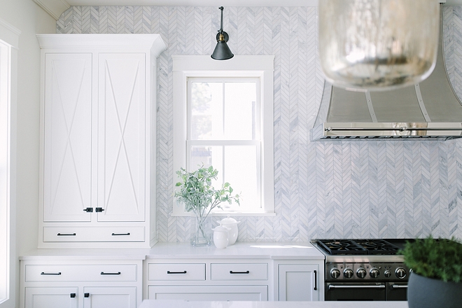 Backsplash is Carrara marble tiled backsplash to ceiling in Chevron Pattern #Backsplash #Carraramarbletiled #kitchenbacksplash #ChevronPattern