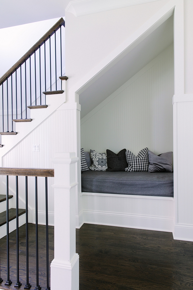 “Hang-out Nook” under second staircase. Isn't this a brilliant idea?! Wainscoting and trim are painted in Simply White by Benjamin Moore Nook under stair Under stair nook #readingnook #understairnook #nookundertsairs