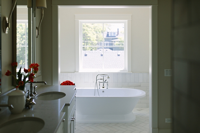 The bathroom also features a separate tub area with Carrara Wainscoting and Freestanding Soaker Tub
