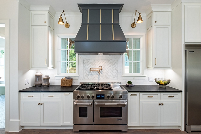 White Kitchen with grey hood and grey island White cabinet paint color is Benjamin Moore White Dove Grey hood paint color is source on Home Bunch #BenjaminMooreWhiteDove