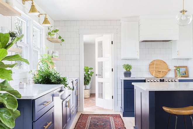 Kitchne The thoughtfully-chosen cabinetry colors, classic square subway tile, modern brass hardware and custom white oak floating shelving bring a bit of fun and whimsy to this classic kitchen #kitchen #cabinetrycolors #classictile #squaresubwaytile #modernbrasshardware #classickitchen 2540 Love ©AlyssaRosenheck