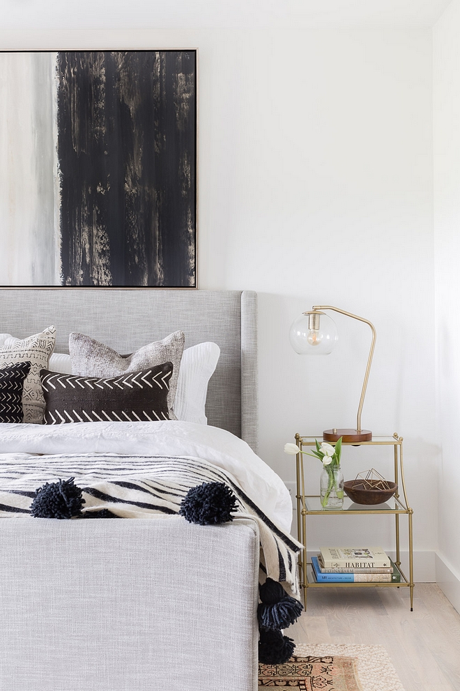 Mid-century Bedroom The master bedroom boasts an upholstered sleigh bed with white linen bedding topped off with a striped wool pompom blanket purchased at a local boutique 2540 Love ©AlyssaRosenheck #MidcenturyBedroom