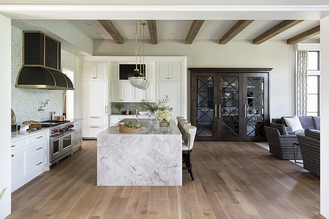 Kitchen A Custom Walnut and Glass door leads to butlers pantry and conceals the kitchen bar #kitchen #butlerpantry #kitchenbar #walnut