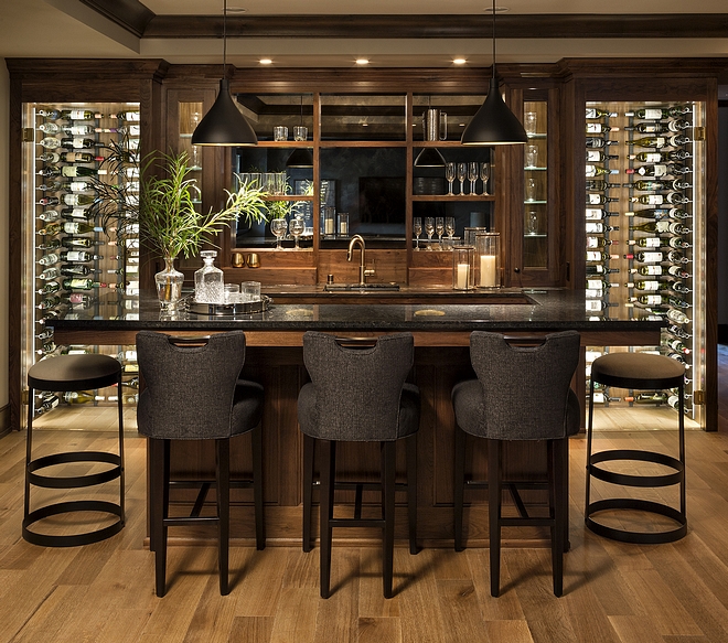 Basement Bar A custom built-in whisky bar and custom-designed abstract glass shelving are just the beginning of an amazing lower level designed for fun #basementbar #bar