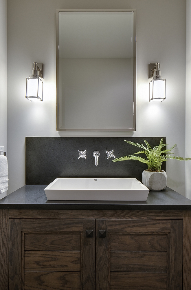 Bathroom features a custom Oak vanity with dark quartz countertop and slab backsplash and a white vessel sink with wall-mount faucet Kohler Purist 
