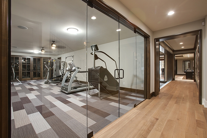 The exercise room features custom stained wood with walls painted in BM Collingwood OC-28