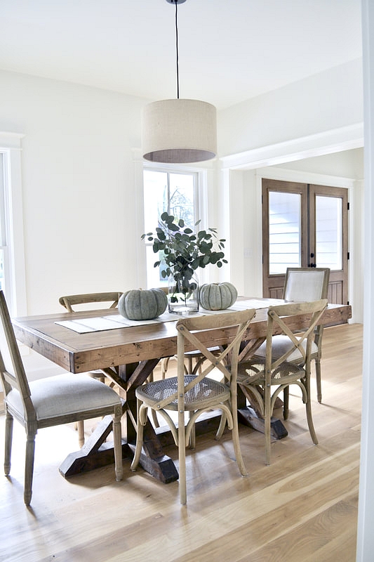 I keep my dining table simple with a striped runner and simple centerpiece of fresh eucalyptus and heirloom pumpkins. I love the color of the blue/grey pumpkins as they are neutral and simple for the fall