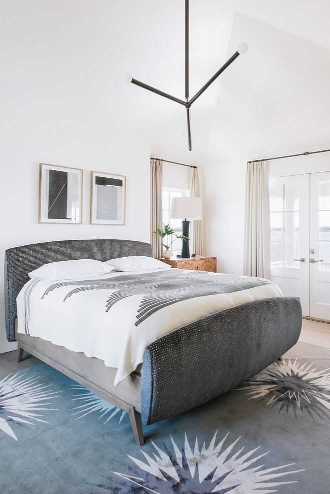 Bedroom Contrasting textures and tones encompass the master bedroom with a velvet upholstered bed, warm burl wood bedside chests, Apparatus lighting, Verellen lamps and a visually impactful rug by Vivienne Westwood #bedroom