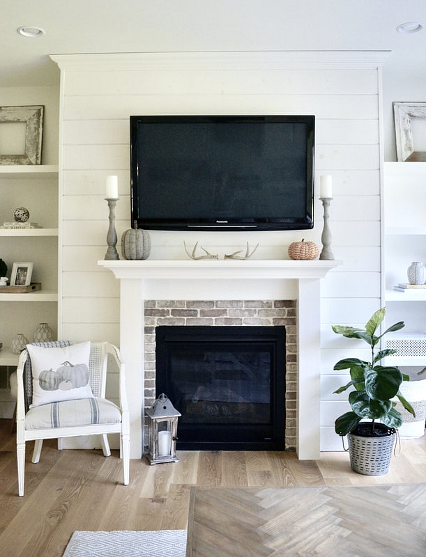 I love adding subtle touches of fall such as this pumpkin pillow and tweed pumpkins on our mantle