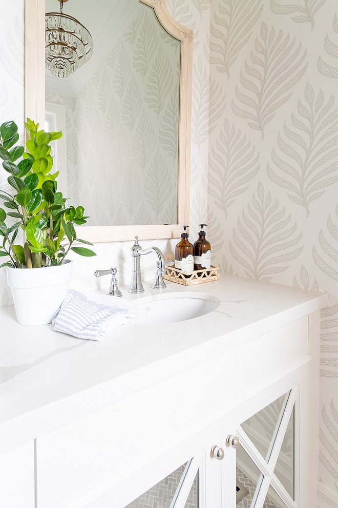 Powder Room with white marble countertop light grey and white wallpaper and bleached woos arched mirror #powderroom #wallpaper #lightgreywallpaper #archedmirror #archmirror