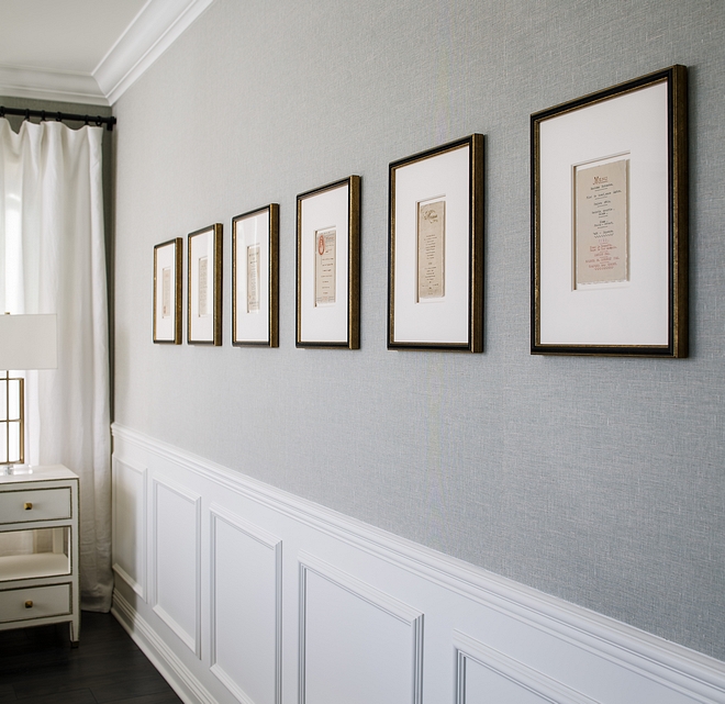 Light grey grasscloth wallpaper above chair rail wainscot