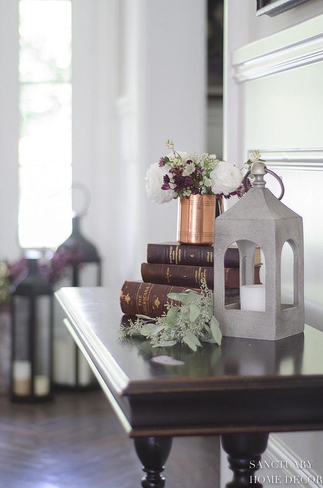 Console table decor vintage books lantern