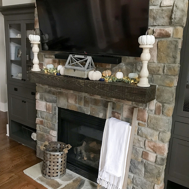 Beam mantel on stone fireplace