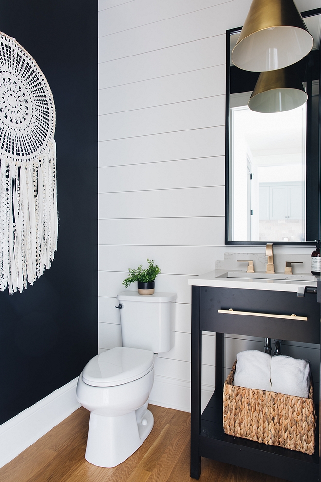 Black and white bathroom The powder room features shiplap and a custom designed vanity painted in Benjamin Moore Black #blackandwhite #bathroom #benjaminmoore #shiplap