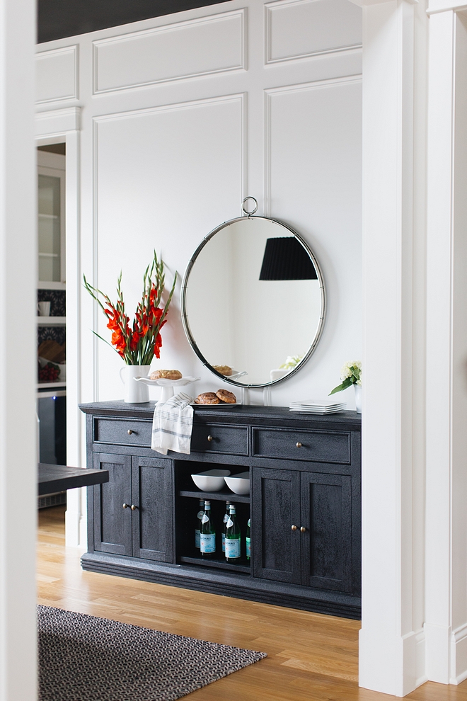 The designer added extensive millwork to the dining room by using panel molding and then painted the whole room in Benjamin Moore’s Simply White - semi gloss #BenjaminMooreSimplyWhite