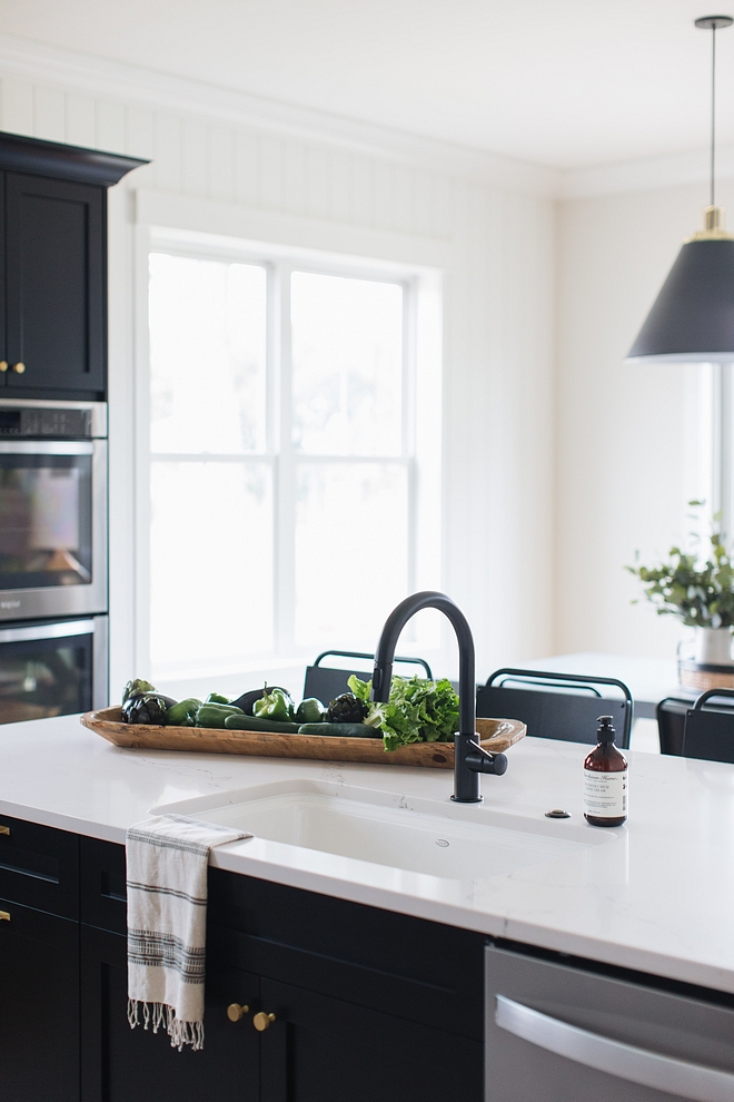 Matte Black kitchen Faucet with white sink and marble-looking quartz countertop over black kitchen cabinets #blackkitchen #blackkitchencabinets #matteblack #MatteBlackkitchenFaucet #MatteBlackFaucet 