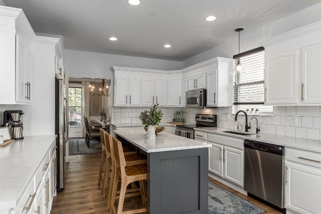 White Kitchen with Stacked Cabinets and Grey Island - Home Bunch