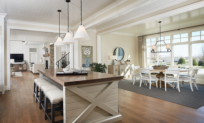 The main kitchen island was designed by me, and we had our cabinet maker company build it. The countertop is Cerused Oak and the base is painted in Benjamin Moore Swiss Coffee. The X-Base is a subtle farmhouse theme in the house (a nod to barn doors). The homeowner has a large family and I wanted to offer them a family gathering area, therefore the island offers seating on both sides #kitcheisland #farmhouse #kicthen #kitchen