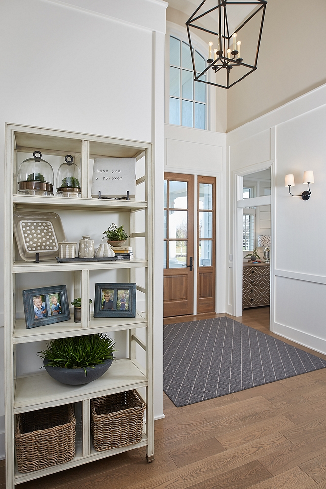 Foyer horizontal board and batten Paneling A custom front door opens to a stunning foyer with White Oak hardwood flooring, arched ceiling and horizontal board and batten paneling #Foyer #horizontalboardandbatten #boardandbatten #Paneling