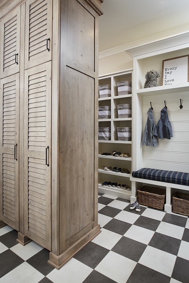 Mudroom Cabinet A custom cabinet with louvered doors divide the mudroom in two areas and keeps things more organized #mudroom #cabinet #louvereddoors #cabinetideas #mudroomdesign #mudroomideas