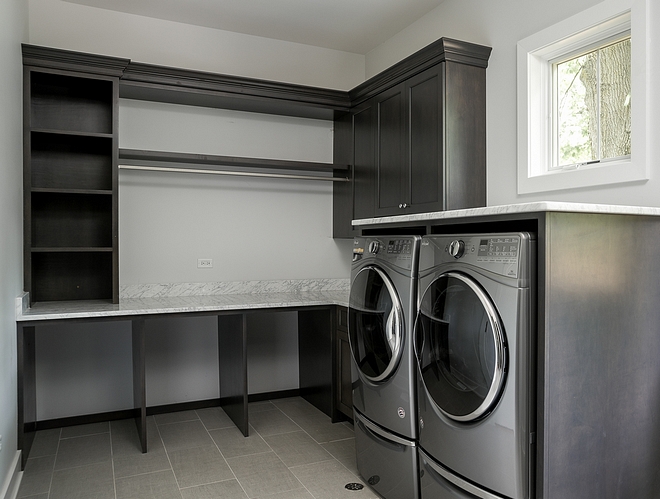 The laundry room features open space for hampers under the counter
