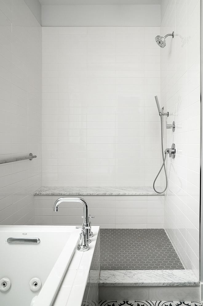 White subway tile with grey floor tile and white marble bench slab to give this affordable shower a more expensive feel #shower #tile
