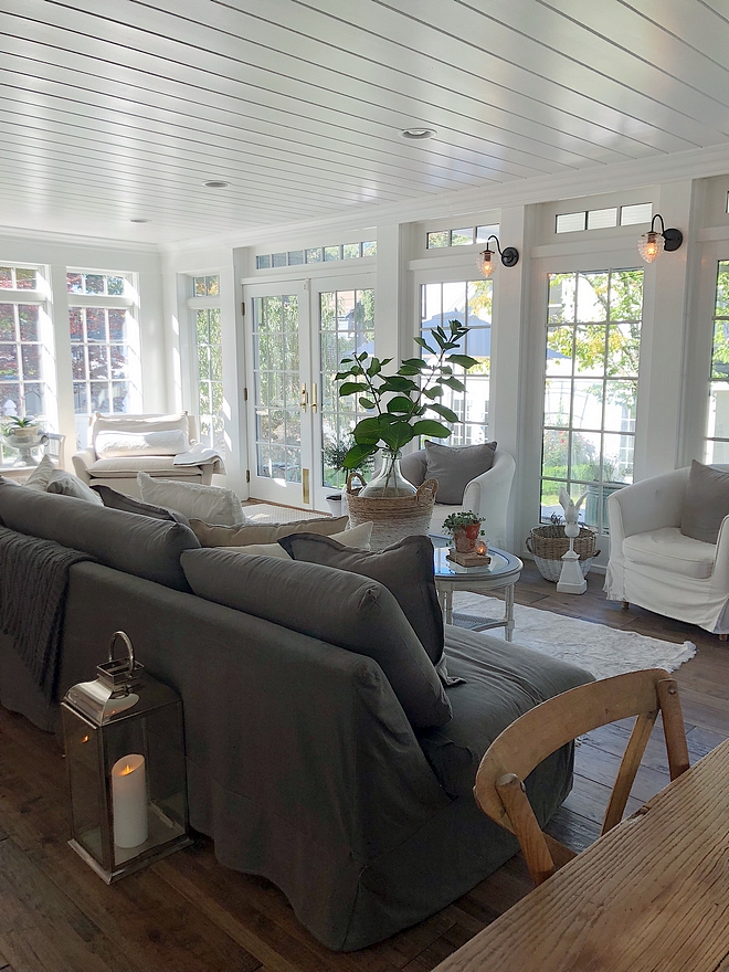 Hamptons inspired family room with tongue and groove ceiling, slipcovered sofas and slipcovered chairs #hamptonsinteriors #Hamptons #slipcoveredsofa #slipcoveredchairs #familyroom