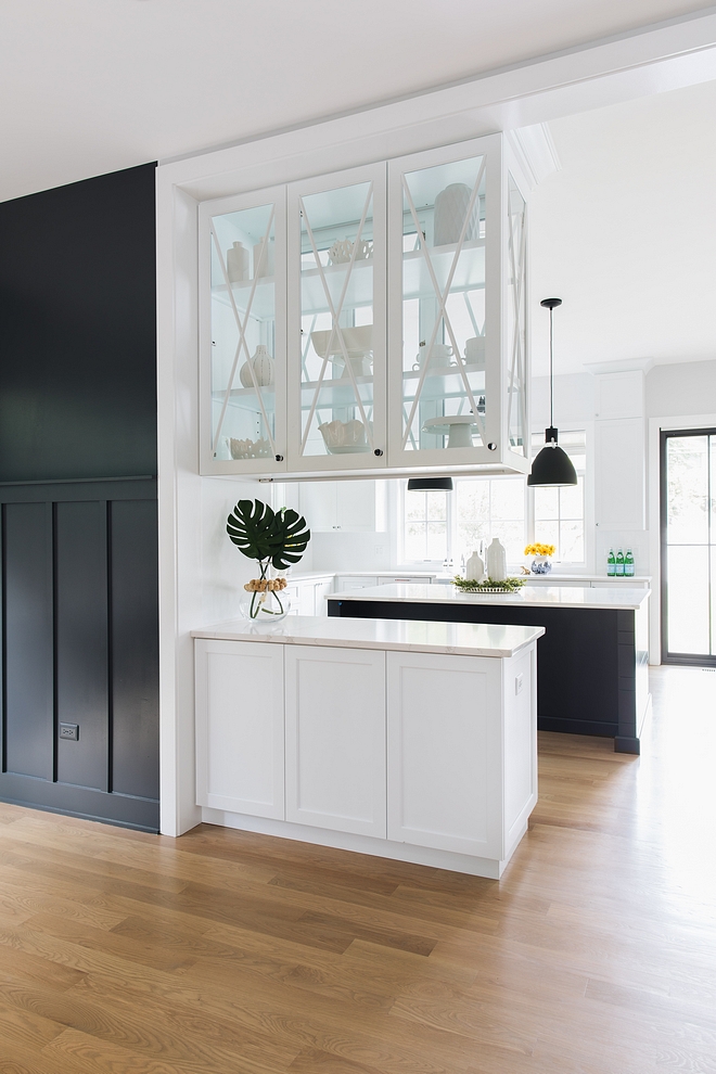 The upper cabinets feature glass doors on both sides, allowing more natural light into the dining room and easy access from either room