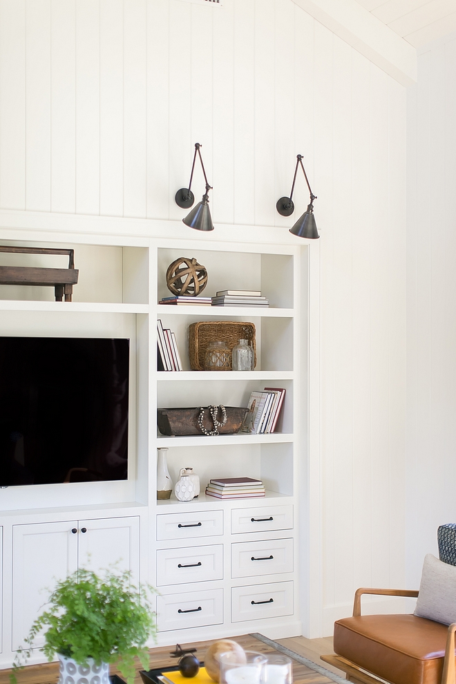 White Builtin media cabinet painted in BM White Dove with black pulls and black knobs above you will find vertical plank