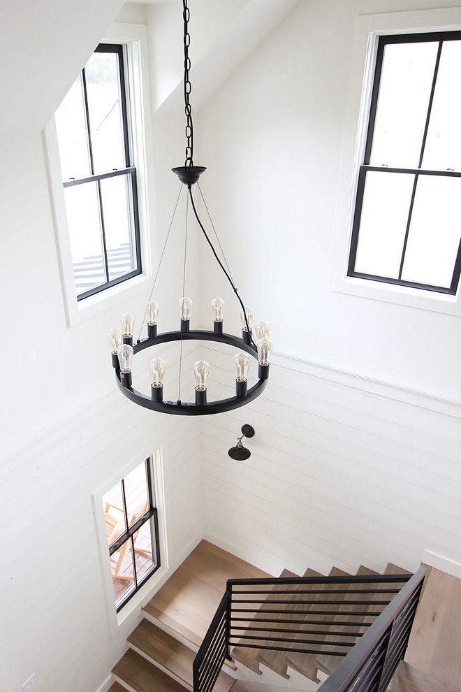 Staircase with White oak treads, black steel windows and shiplap paneling Shiplap was installed on half wall to keep things on budget Staircase #sataircase #staircasetreads #shiplap #halfwallshiplap #shiplappaneling #blackwindows