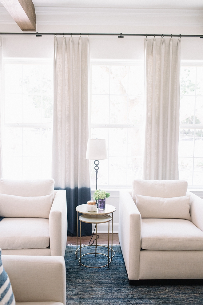 White linen chair Accent chairs Pair of white linen chairs against Blue Ombre dipped linen draperies and blue jute rug See sources on Home Bunch #Whitelinenchair #Accentchairs