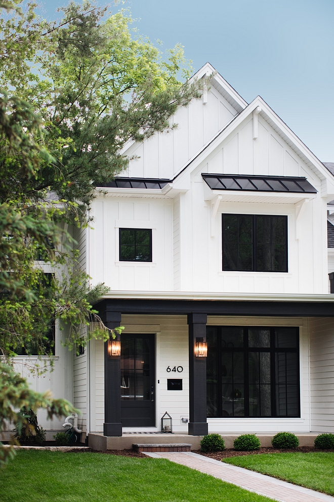 White batten and board exterior with black porch columns, black windows and black metal roof Modern farmhouse White batten and board exterior White batten and board exterior #Whitebattenandboard #whiteexterior #farmhouse #farmhosue #modernfarmhouse