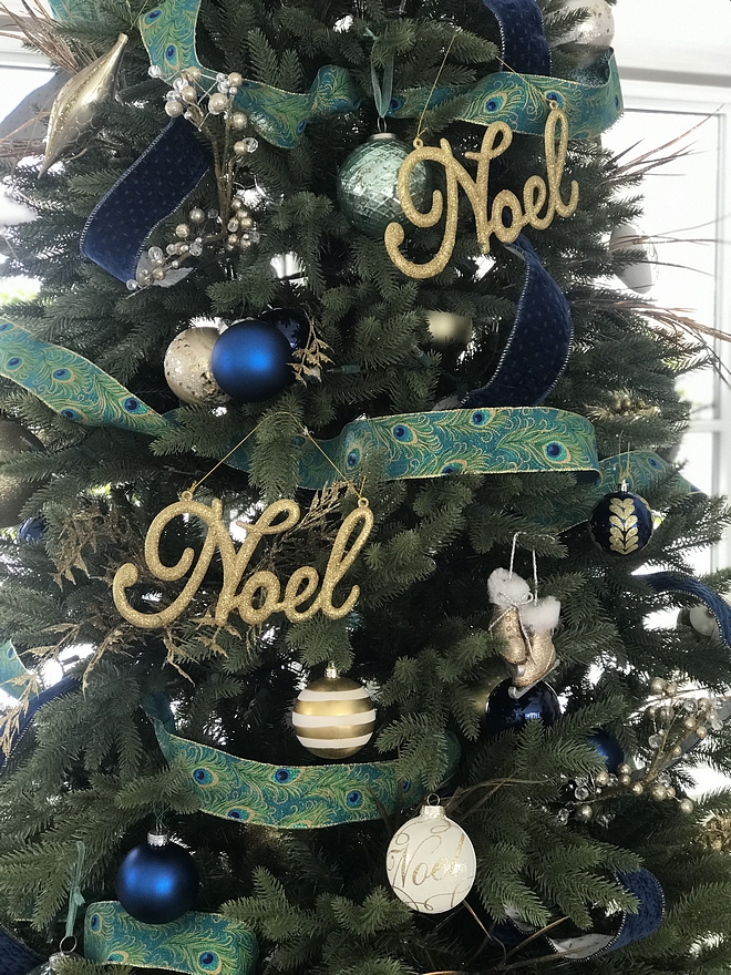 This 9 foot tall tree is the perfect height for the sunroom. This year, I found a large roll of pretty peacock ribbon at Costco and knew the shades of blue were perfect for the sunroom tree. I was able to wrap the whole tree and still have a substantial amount of ribbon left! I added blue balls from Canadian Tire and Michales and added gold filler