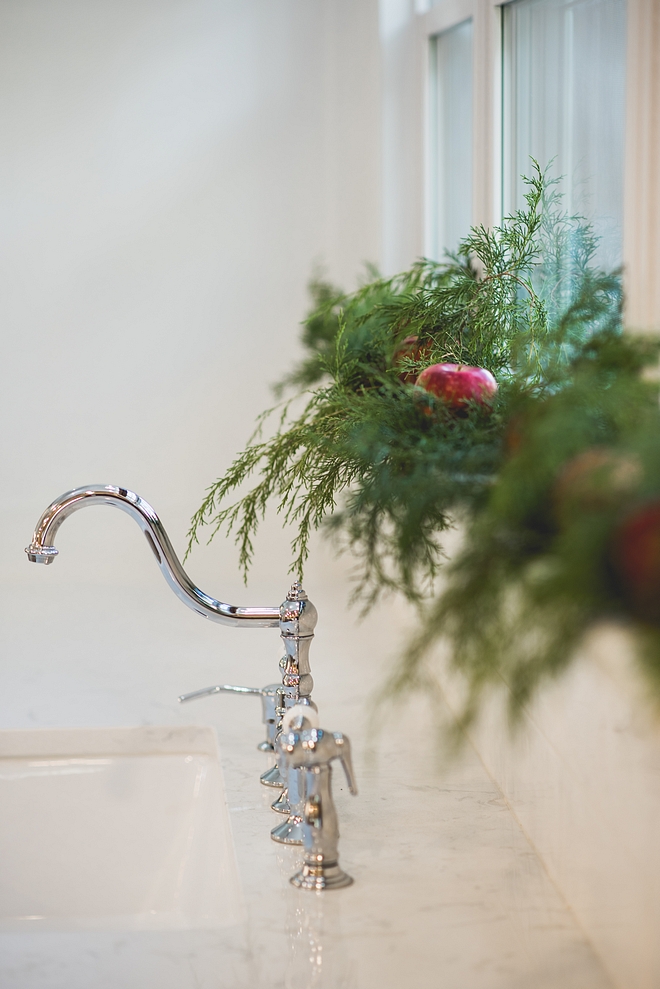 My kitchen area is full of cedar and apples! Apples in the window sills. Apples dotting the runner on my dining room table. And a dough bowl full of apples on my kitchen island! All natural, boxwood wreaths grace the triplet windows above my kitchen sink