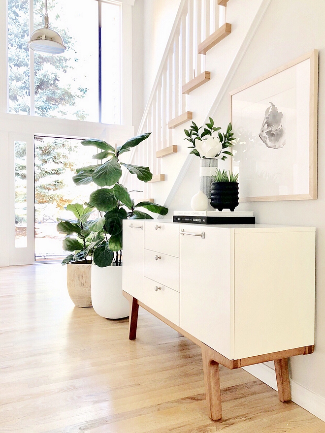 Entryway ideas In our entryway we chose to use three large stainless steel pendants that are also in our kitchen, instead of one chandelier. One of the things that we loved when we saw our house for the first time was all the glass and the large window above the front door #entryway