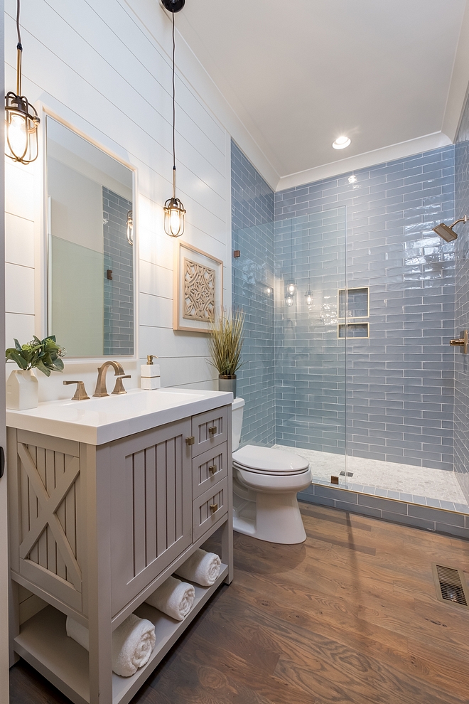 Coastal Farmhouse bathroom with shiplap walls, store-bought vanity and hardwood flooring and blue subway tile Neutral coastal Farmhouse bathroom Farmhouse bathroom ideas #coastalFarmhousebathroom #coastalbathoom #Farmhousebathroom #bathroom