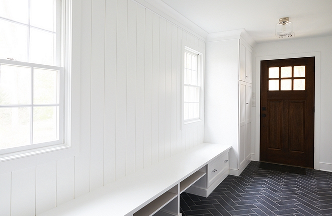 Mudroom with tongue and groove painted Benjamin Moore Chantilly Lace and Slate herringbone floor tile #mudroom #herringbonefloortile #mudroombench #paintcolor #BenjaminMoorechantillylace #mudrooms #tongueandgroove