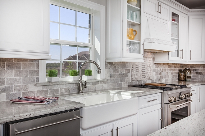 White kitchen with tumbed backplash tile and white granite countertop #kitchen #backsplash #countertop