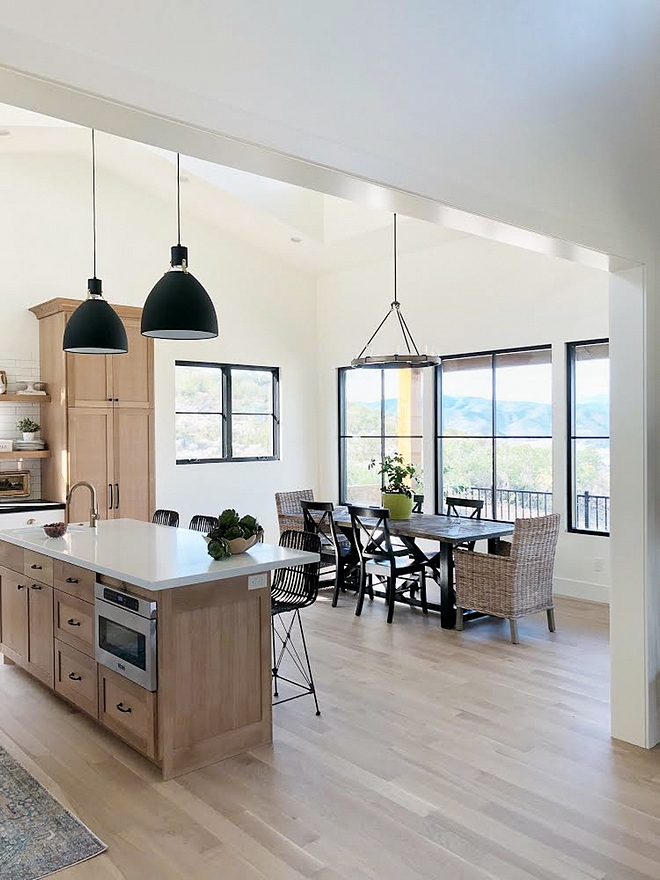 Modern Farmhouse dining room with black steel windows walls in Benjamin Moore Simply White and White Oak cabinets #ModernFarmhousediningroom #blacksteelwindows