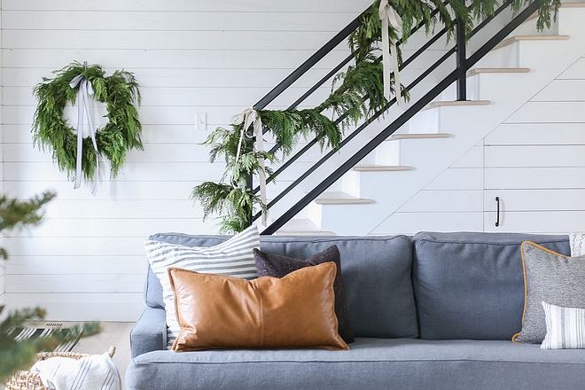 Under stair storage A door was added under the stairs to take advantage of the storage space Walls and door are covered in shiplap