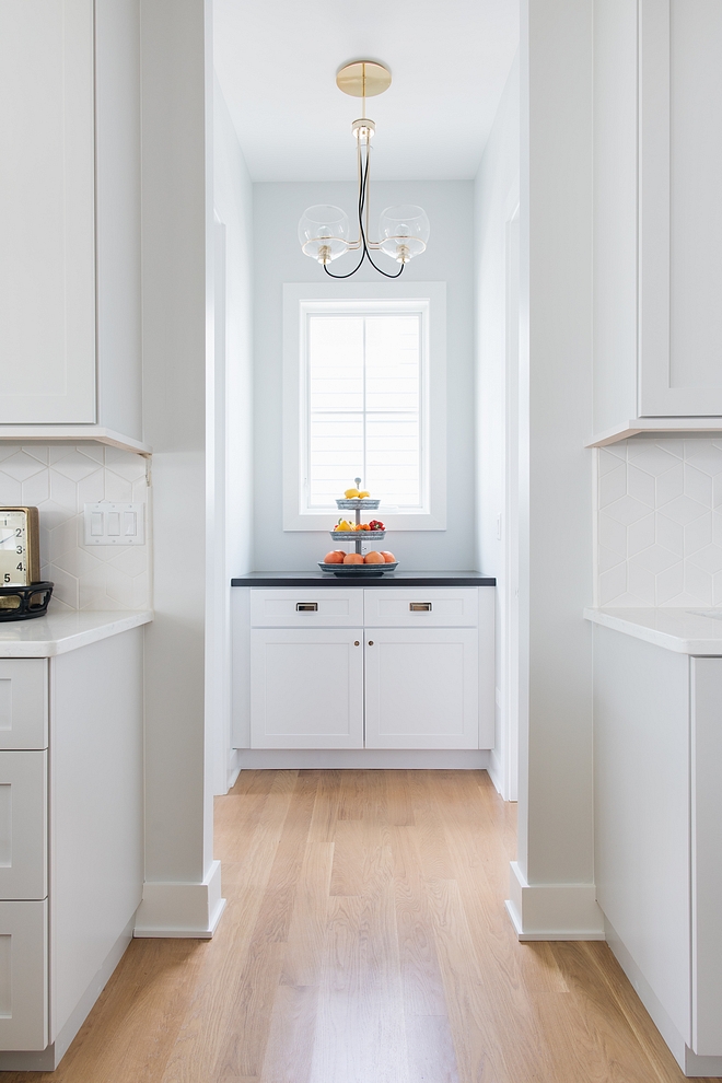 Butler's Pantry A custom cabinet is located on a hall that leads to the mudroom and pantry area #cabinet #ButlersPantry