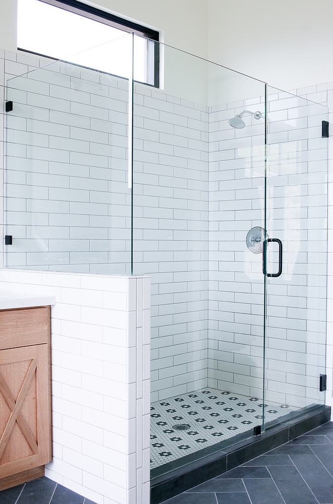 Shower with white subway tile on walls and Hex Matte White with Flower tile on flooring #subwaytile #HexMatteWhite #flowertile #flooring #showertile #shower #tile