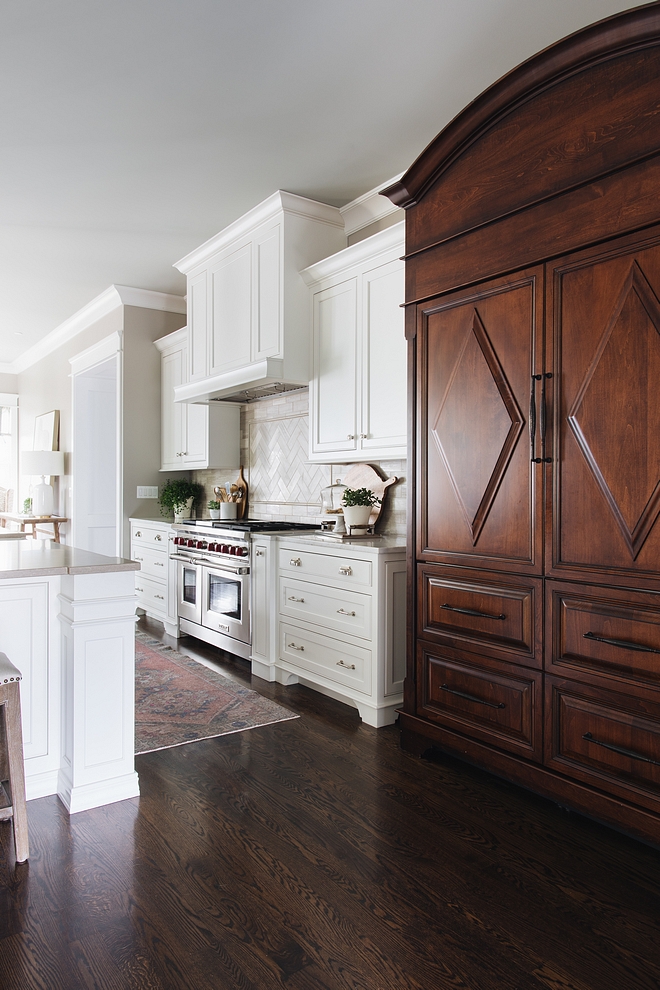 Kitchen features white inset, custom-designed and crafted cabinetry and medium-stained refrigerator cabinet #kitchen #kitchencabinet #Kitcheninsetcabinet #cabinet #cabinetry #refrigeratorcabinet