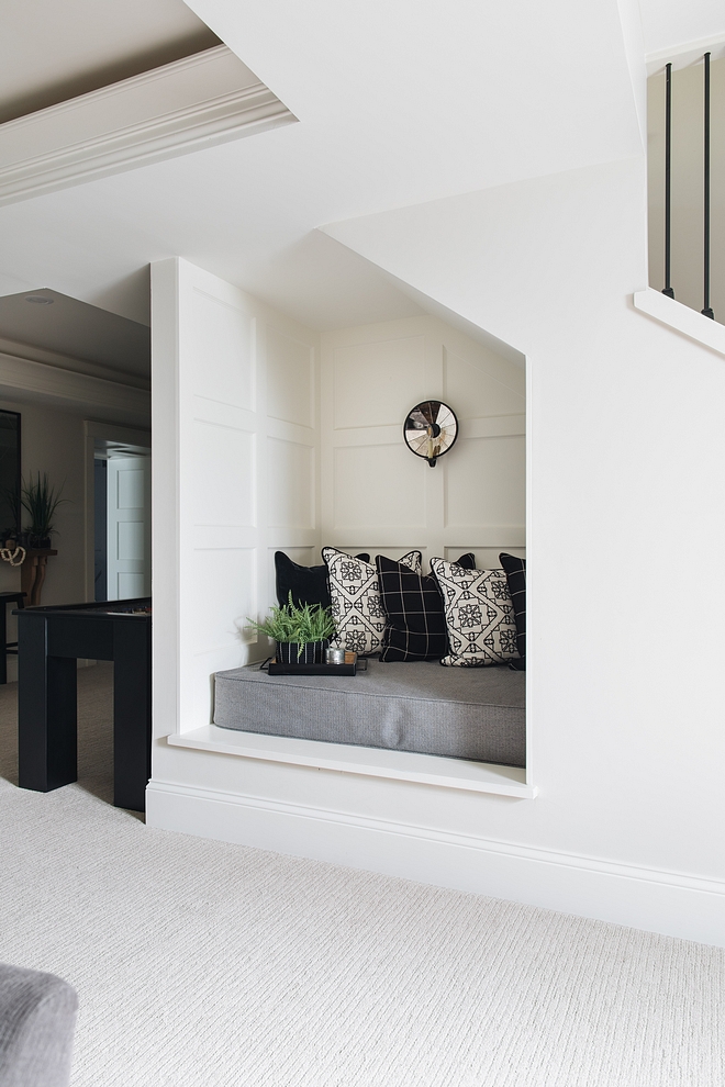 Reading Nook Located under the staircase, this adorable reading nook features grid board and batten #readingnook #baordandbatten #gridboardandbatten