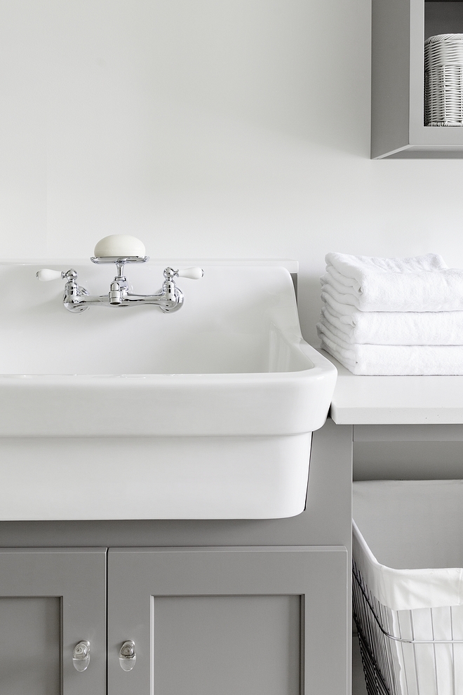 Laundry room with grey cabinet, white quartz countertop and white utility sink with utility faucet #laundryroom #greycabinet #whitequartz #countertop # utilitysink #utilityfaucet #laundryrooms